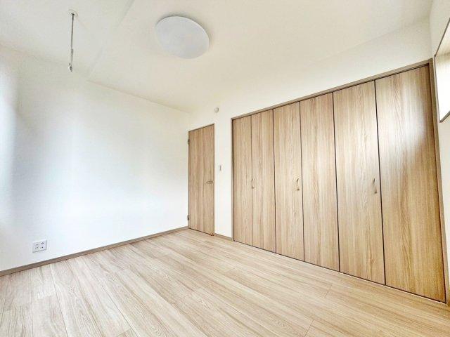 【2号棟】　洋室には雨の日でも干すことが出来る室内物干し、収納たっぷりの壁一面収納があります。